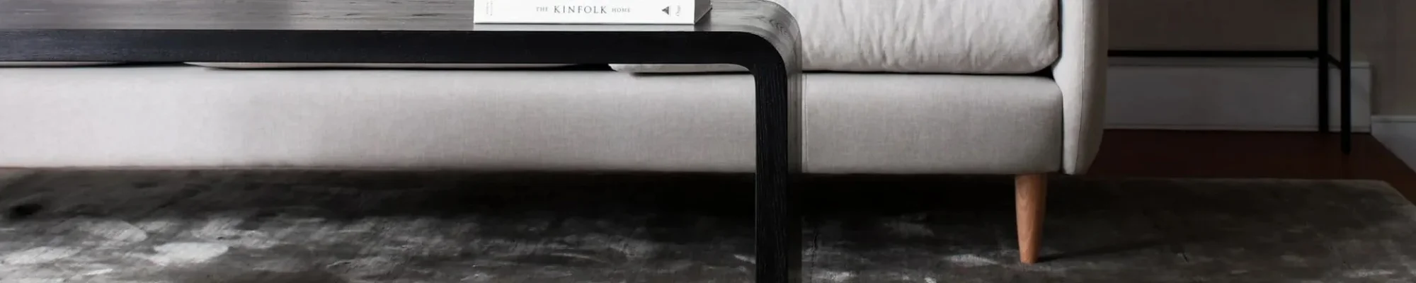 white couch and black coffee table on a brown hardwood floor from Johnson & Sons Flooring in Knoxville, TN